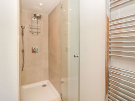A shower area with tiled walls and a towel rail at 33 Dart Marina in Dartmouth
