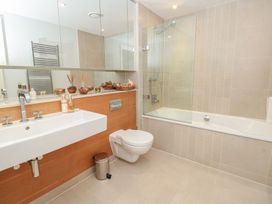 A bathroom with a sink, bath, and toilet at 33 Dart Marina in Dartmouth