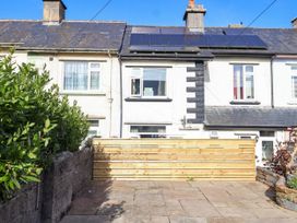 An outdoor area with a wooden fence and patio at Angels Place in Yelverton