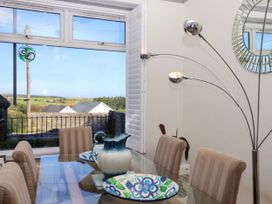 A dining room featuring a table with chairs and a view at Angels Place in Yelverton