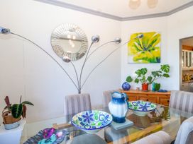 A dining room with a table and chairs at Angels Place in Yelverton