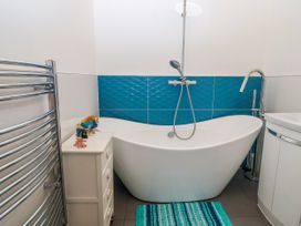 A bathroom with a bathtub and sink at Angels Place in Yelverton