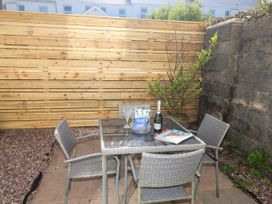 A garden with a table and chairs at Angels Place in Yelverton