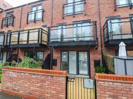 An apartment building with balconies and a gate at Blanket Row in Hull