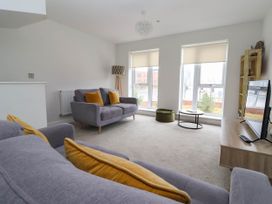 A living room with two sofas and a television at Blanket Row in Hull