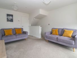 A living room with sofas and a table at Blanket Row in Hull