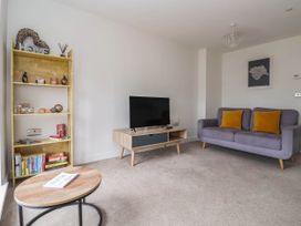A living room with a sofa and television at Blanket Row in Hull