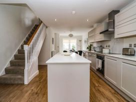A kitchen with a staircase and kitchen island at Blanket Row in Hull