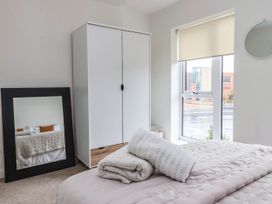 A bedroom with a bed and wardrobe at Blanket Row in Hull