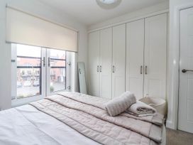 A bedroom with a bed and wardrobe at Blanket Row in Hull