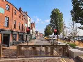 A view of Humber Dock Street with buildings and trees in Hull