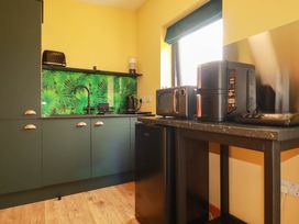 A kitchen with appliances including a refrigerator and microwave at The Hyde, Tazamble cottage, Launceston