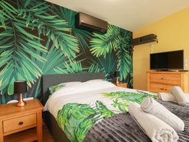 A bedroom with a bed and television at The Hyde, Tazamble cottage, Launceston