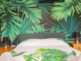 A bedroom with a bed and bedside tables at The Hyde, Tazamble cottage in Launceston
