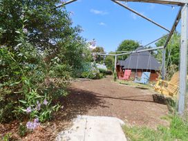 A garden with a swing set and a shed at The Hyde, Tazamble cottage in Launceston