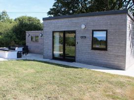 A modern building with patio and seating area at The Hyde Clubworthy near Launceston