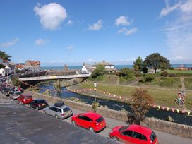 A view of a river and bridge with cars parked at Old Lyn Cottage in 