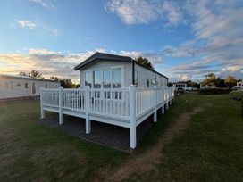 A holiday home with a deck in an outdoor area at Haggerston Castle - Lakeside Retreat, Berwick-upon-Tweed