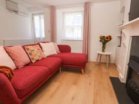 A living room with a red sofa and a coffee table at Top Deck St. Ives