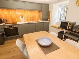 A kitchen with a dining table and chairs at Top Deck in St. Ives