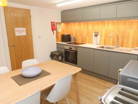 A kitchen with a table and chairs at Top Deck in St. Ives