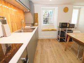 A kitchen with sink and induction cooktop at Top Deck in St. Ives