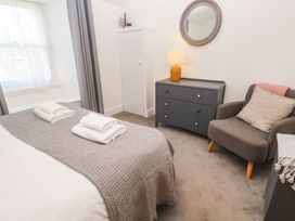A bedroom with a bed and towels on top at Top Deck in St. Ives