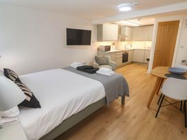 A studio with a bed and kitchen area at The Cabin in St Ives