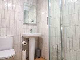 A bathroom with a sink and shower at The Cabin in St Ives