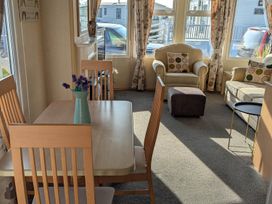 A living room with a dining table and chairs at Beachcomber Cabin Dog Friendly Anderby Creek Lincolnshire