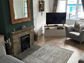 A living room with a fireplace and television at The Old Barn in Manchester