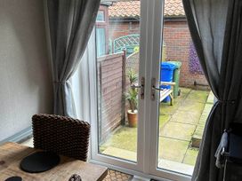 A dining room with a view of the garden at The Old Barn in Manchester
