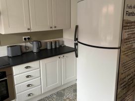 A kitchen with appliances and storage containers at The Old Barn in Manchester