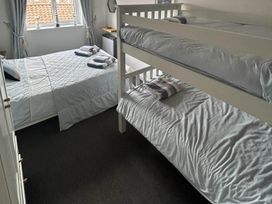 A bedroom with a double bed and a bunk bed at The Old Barn in Manchester