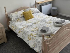 A bed with pillows and towels in a bedroom