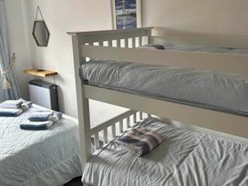 A bedroom with a bunk bed and double bed at The Old Barn in Manchester