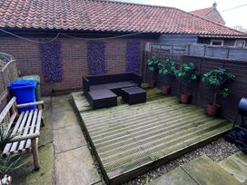 A garden with decking and furniture at the property in the unspecified location