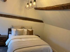 A bedroom with a bed and nightstand at the property