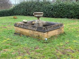 A stone fountain in a garden