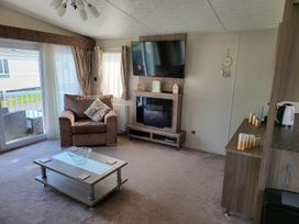 A living room with a sofa and television at the property in the location