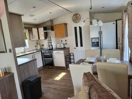 A kitchen with dining table and appliances at the property in 