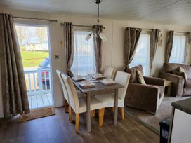 A dining room with a table and chairs at '' in ''