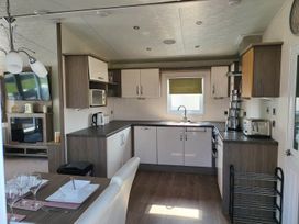 A kitchen with appliances and dining setup at The Old Barn in Manchester