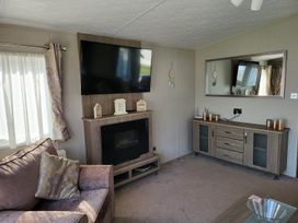 A living room with a television and fireplace at a property