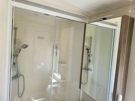 A bathroom with a shower and a toilet