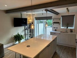 A kitchen with an island and television at the property in the location