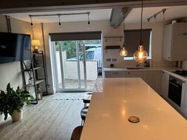 A kitchen with island seating and sliding doors at The Old Barn in Manchester