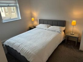 A bedroom with a bed and nightstands at the property in location