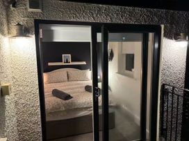 A bedroom with a bed and shelf at the property location