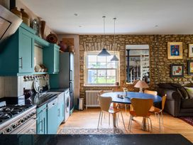 A kitchen with a dining table and chairs at Beautiful Pad Near World Heritage Jurassic Coast in Pymore near Bridport